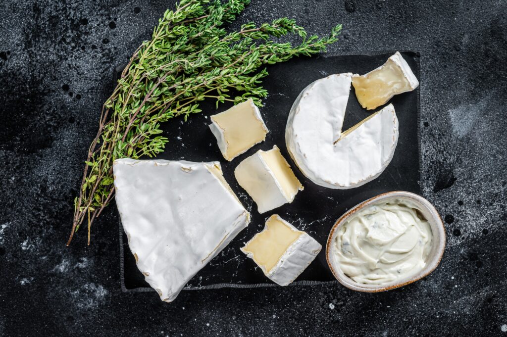Cheese platter. Camembert, Brie, Gorgonzola and blue cream cheese with thyme.
